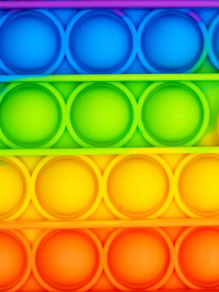 Parlak, popüler bir doku. Renkli moda anti-stres oyuncakları. Kıpırdayın, kıpırdayın, kımıldayın. Arkaplan.