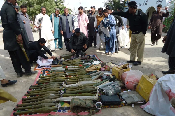 Police officials show seized weapons suicide jackets and explosive material — Stock Photo, Image