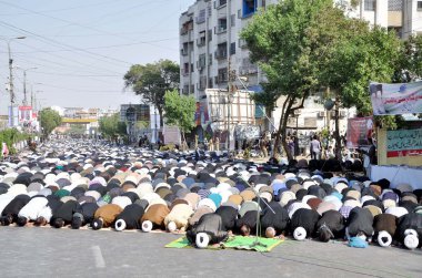 Shiite mourners offer afternoon payer during mourning procession in connection of Chehlum (Fortieth Day Mourning Commemoration) of Hazrat Imam Hussain (A.S) clipart