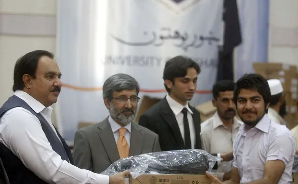 Le ministre fédéral de la Santé, Zahir Ali Shah, distribue des ordinateurs portables aux étudiants, à l'occasion de la Journée de la collation des grades — Photo