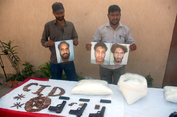CID Oficiales del ala de lucha contra el terrorismo muestran armas incautadas durante conferencia de prensa mientras los funcionarios del CID detenían a tres activistas de Lashkar-e-Jhangvi durante una revisión rápida —  Fotos de Stock