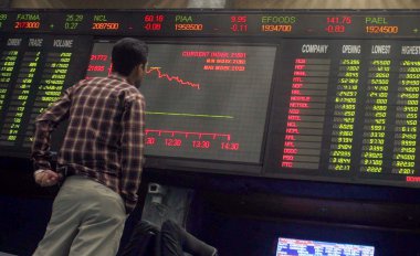 A Pakistani trader monitors trade prices at Karachi Stock Exchange (KSE), in Karachi, on Tuesday, July 02, 2013 clipart