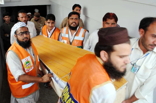 Rädda tjänstemän SKIFT döda kroppen av bombexplosion nära ett sjukhus på sulemankhel område offer, på lokala sjukhus i peshawar — Stockfoto