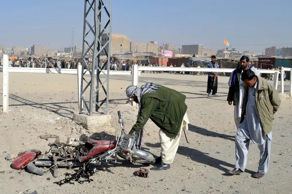 Police officials are gathering around the motor cycle after bomb blast, unknown people planted the bomb in motor cycle, and parked near the Government Girls collage Stock Picture