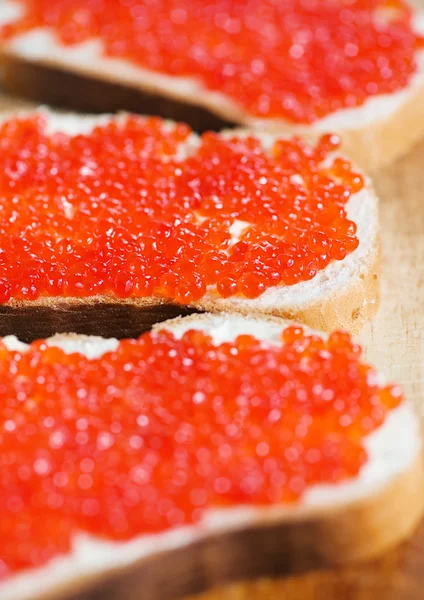 Red caviar on a slice of bread — Stock Photo, Image