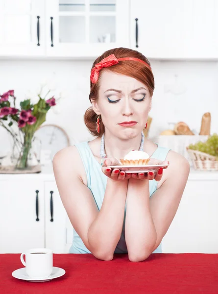Sad beautiful woman looking on cake Royalty Free Stock Images