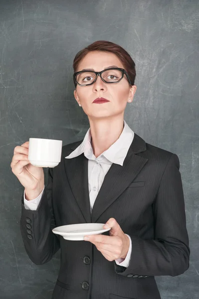Serious teacher with cup of coffee — Stock Photo, Image
