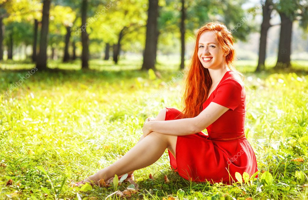 Redhead bending outdoor woman