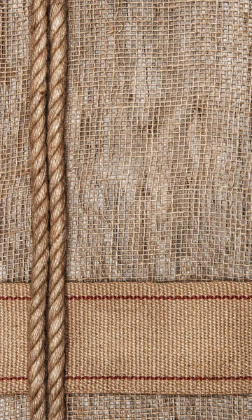 Burlap background with sacking ribbon and rope — Stock Photo, Image