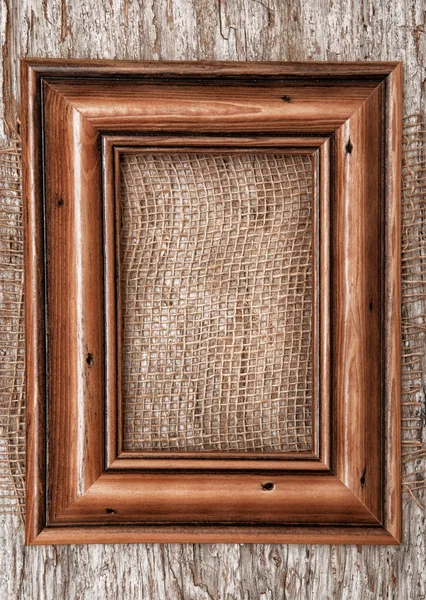 Marco de madera y tela de arpillera en la madera vieja —  Fotos de Stock