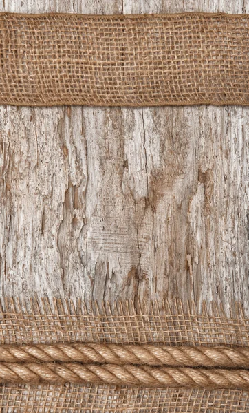 Rope and burlap textile on the old wood — Stock Photo, Image
