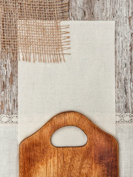 Canvas, burlap and linen fabric with cutting board — Stock Photo, Image