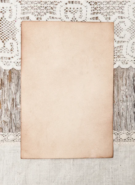 Aged paper and linen fabric on the old wood — Stock Photo, Image