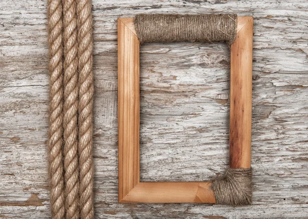 Wooden frame and rope on the old wood — Stock Photo, Image