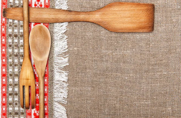 Burlap background bordered by country cloth and utensils — Stock Photo, Image