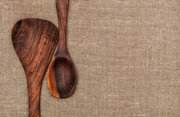 Wooden utensils on burlap background — Stock Photo, Image