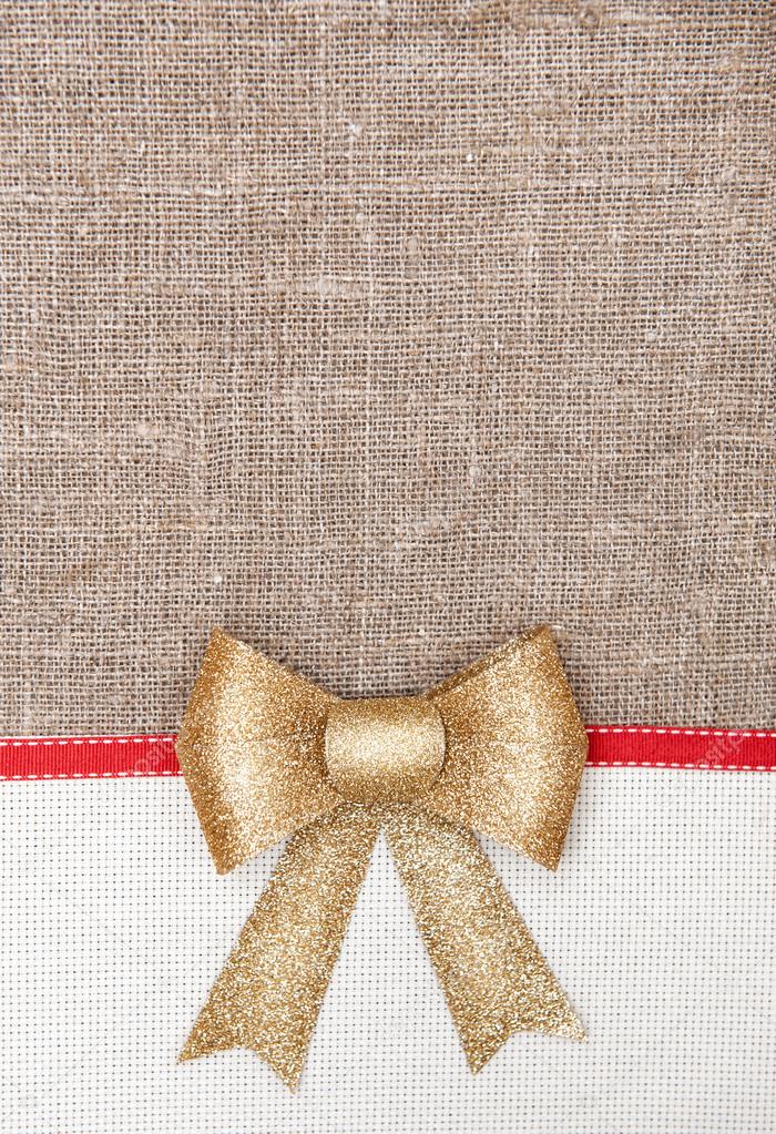 Christmas card with canvas, red ribbon on burlap