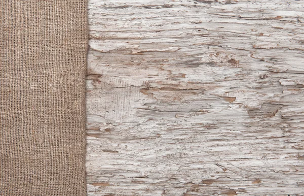 Old wood bordered by burlap — Stock Photo, Image