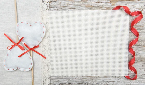Valentine background with textile hearts and ribbon on old wood — Stock Photo, Image