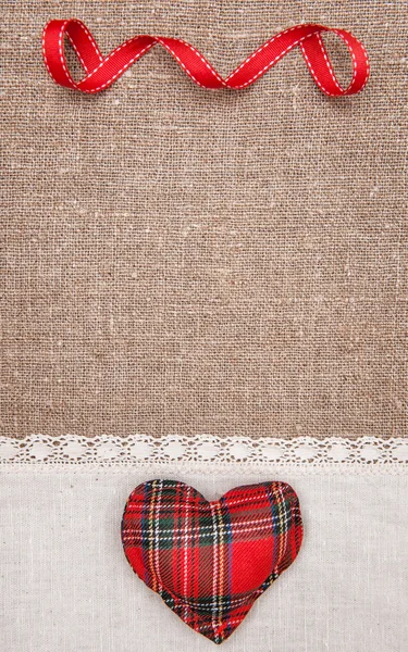 Textile heart and linen cloth on the burlap — Stock Photo, Image
