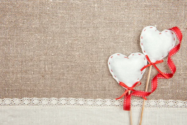 Textile hearts, ribbon and linen cloth on the burlap — Stock Photo, Image