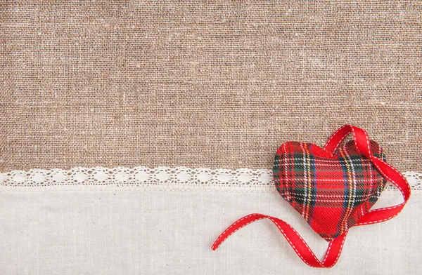 Textile heart, ribbon and linen cloth on the burlap — Stock Photo, Image