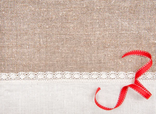Invitation card with ribbon and linen fabric on the burlap — Stock Photo, Image