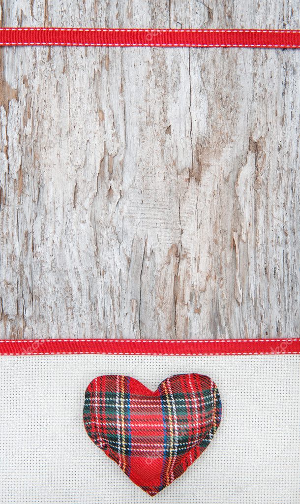 Valentine card with textile heart on canvas and old wood