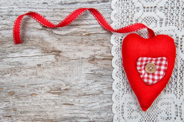 Valentine card with textile heart on lacy cloth and old wood — Stock Photo, Image