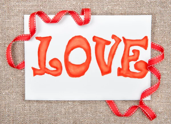 Valentine card with drawing word love and ribbon — Stock Photo, Image