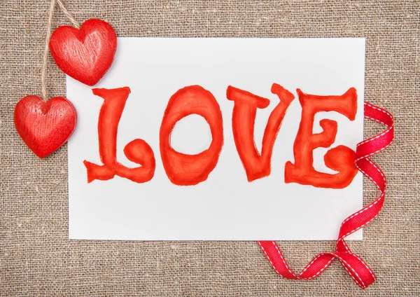 Valentine card with drawing word love and ribbon — Stock Photo, Image