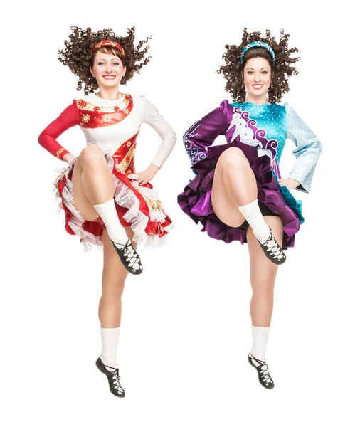 Two young women in irish dance dress dancing isolated — Stock Photo, Image