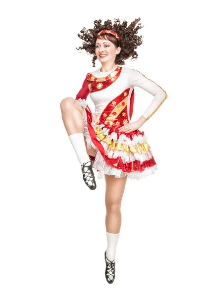 Young woman in irish dance dress dancing isolated — Stock Photo, Image