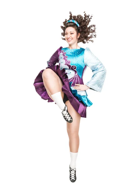 Young woman in irish dance dress dancing isolated — Stock Photo, Image