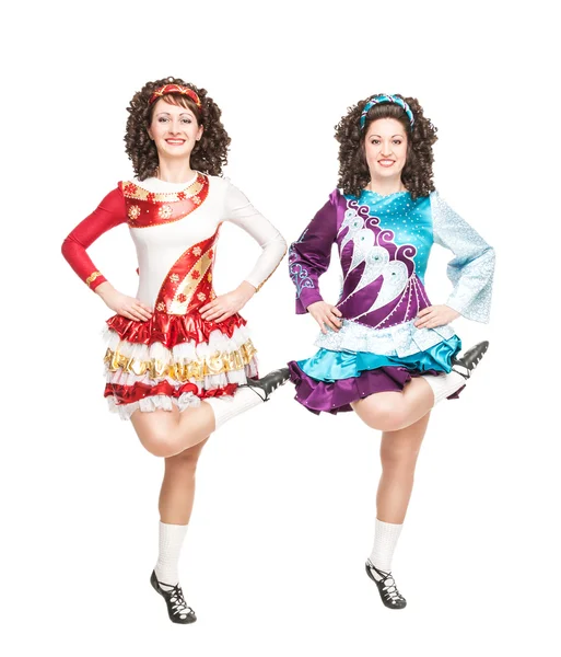 Two young women in irish dance dress dancing isolated — Stock Photo, Image