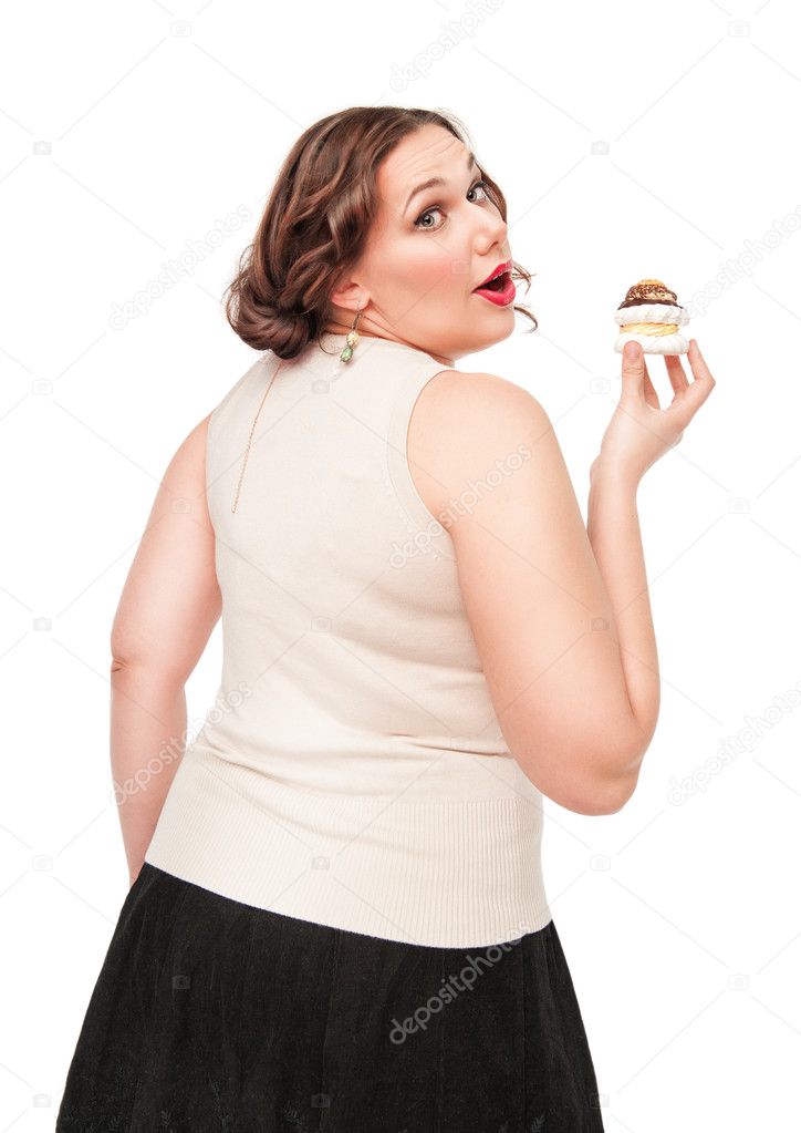 Beautiful plus size woman eating pastry