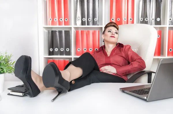 Business woman relax with legs on the table — Stock Photo, Image