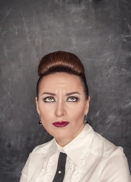 Woman with a skeptical expression looking up above — Stock Photo, Image