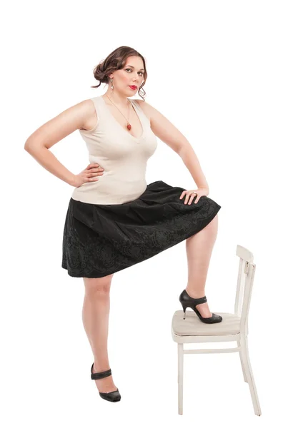 Beautiful plus size woman with chair — Stock Photo, Image