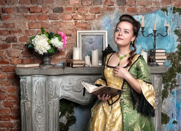 Beautiful woman in medieval dress with book — Stock Photo, Image