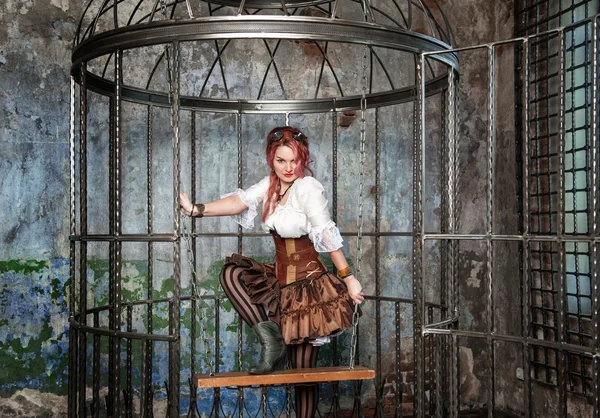 Beautiful sexy steampunk woman in the cage — Stock Photo, Image