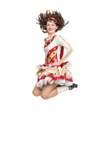 Young woman in irish dance dress jumping — Stock Photo, Image