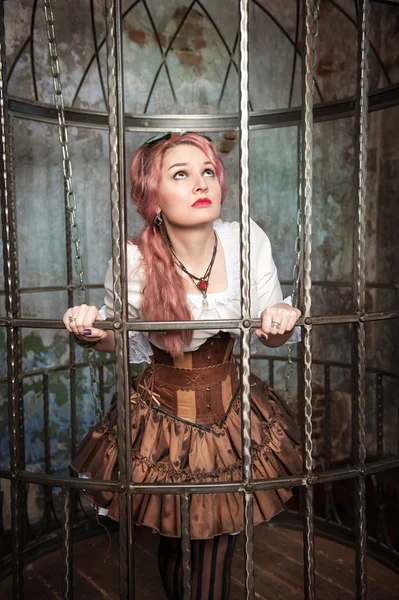 Verängstigte schöne Steampunk-Frau im Käfig — Stockfoto