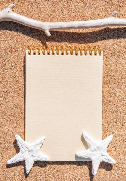 Sheet of paper and seashells on the sand — Stock Photo, Image