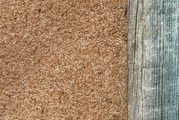 Sand background with old wood — Stock Photo, Image