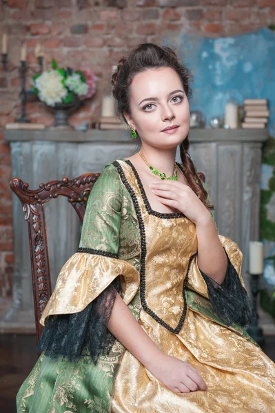 Hermosa mujer en vestido medieval en la silla — Foto de Stock