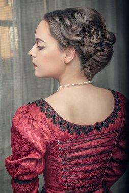 Beautiful medieval woman in red dress 