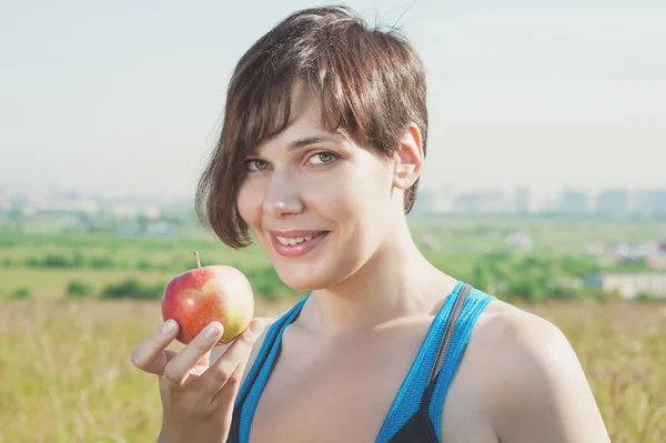 Beautiful fitness woman with apple — Stock Photo, Image
