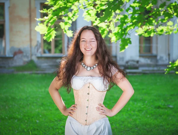 Beautiful woman in corset and trousers winking — Stock Photo, Image