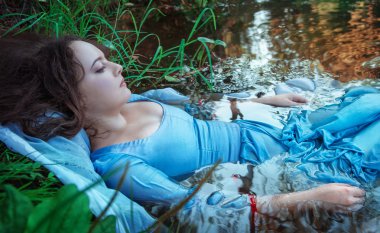 Young beautiful drowned woman lying in the water clipart
